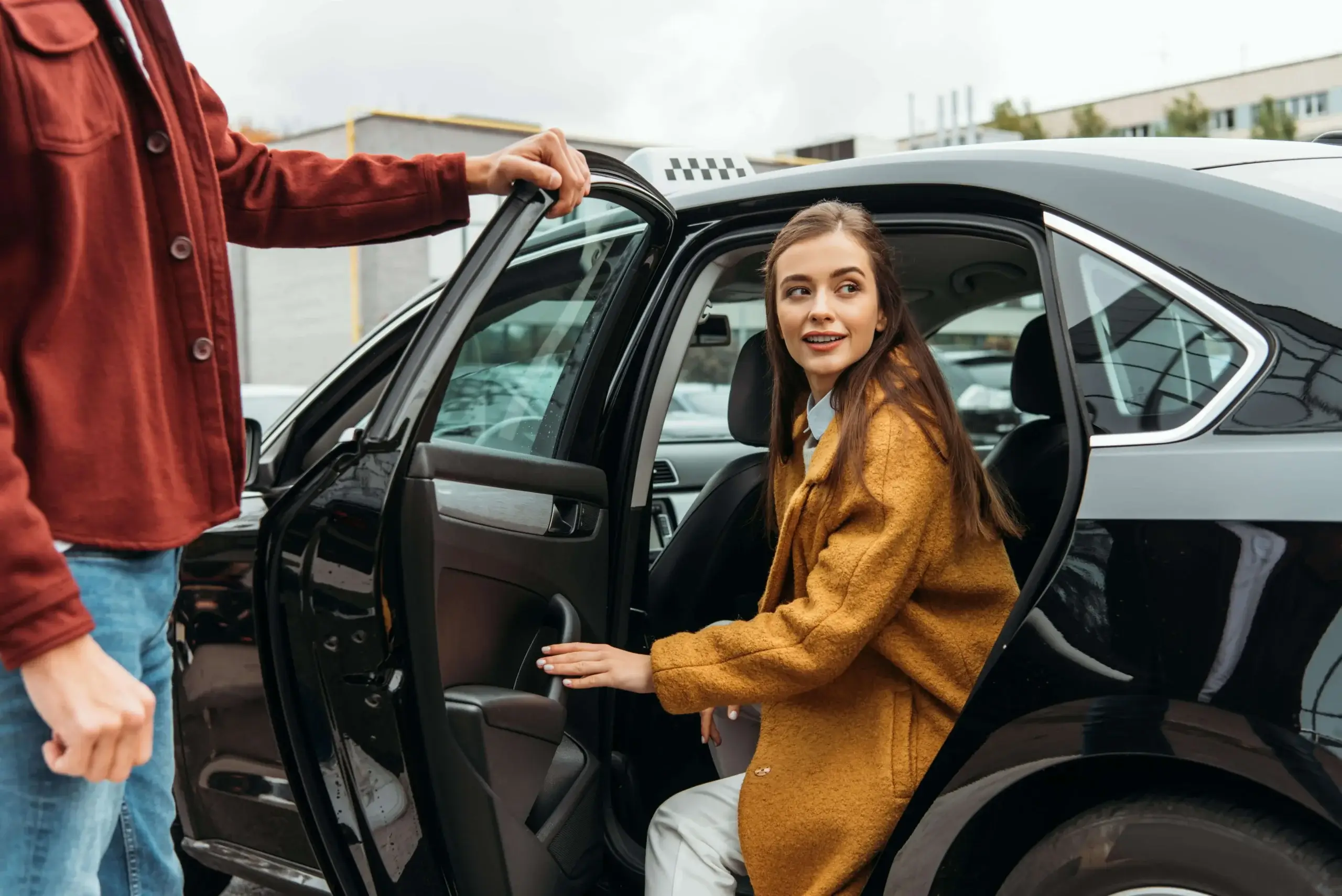 Gatwick-taxi-driver-opening-car-door-for-smiling-woman