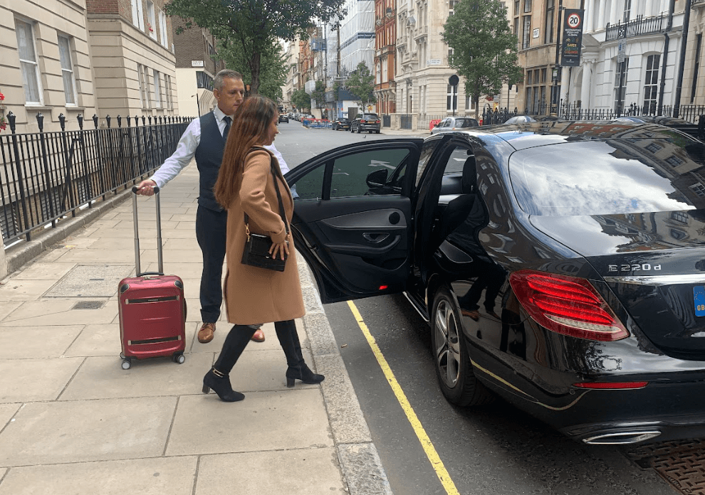 Women getting in to airport taxi